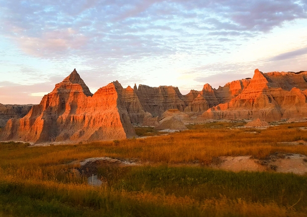 Scattered clouds and sunset glow at Badlands National Park SD 