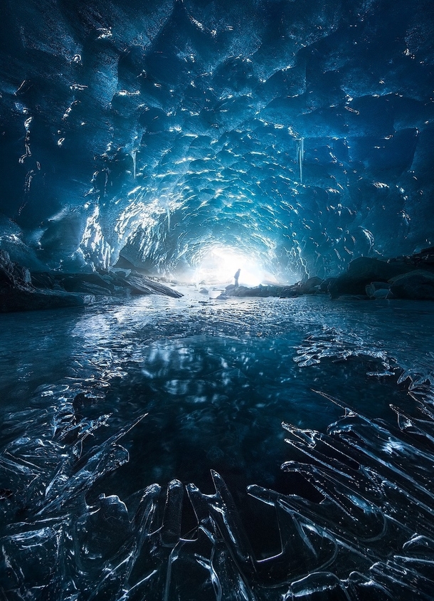 Shine - sunshine reaching into the blue ice caves of Alaska  by Marc Adamus x-post rUnitedStatesofAmerica