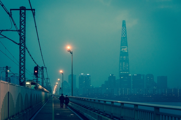 Smoggy evening on the Jamsil Bridge Lotte Tower looming beyond Seoul South Korea 