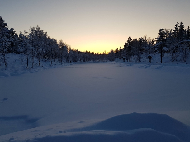 Snow covered lake at Kakslauttanen in Finland  x