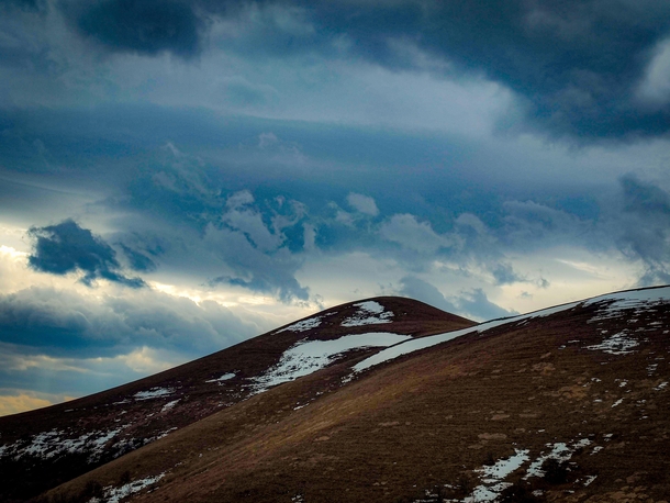 Snowy mountain overlooking dark clouds Lori region Armenia 