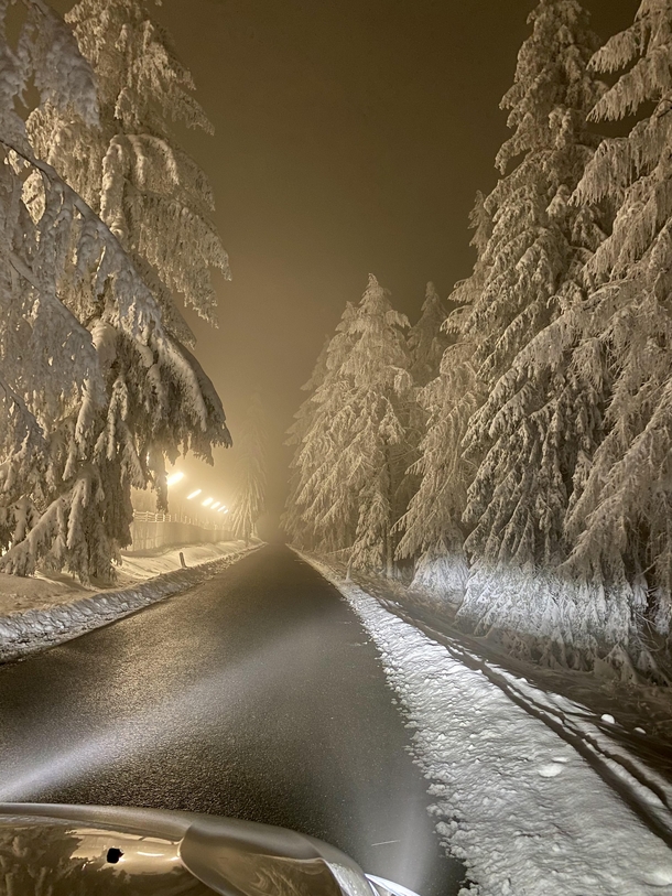 Snowy road leading to military training grounds at midnight