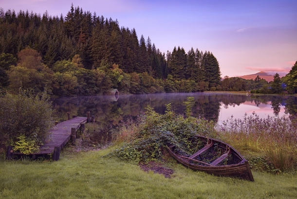 Something different A beautiful view of an Abandoned Dock and Rowboat Loch Ard Trossachs Scotland by John McSporran 