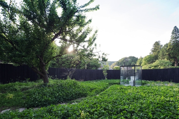 Sou Fujimotos public toilet in Ichihara is a garden escape the glass box lavatory sits in the middle of a  sqm garden enclosed by a  meter wooden log roll fence to maintain privacy 