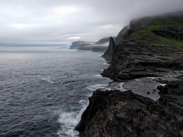 Standing on the edge of the world Lake Srvgsvatn Faroe Islands 