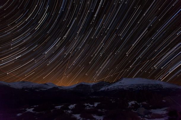 Star Trails and Airplanes over Mt Evans in Colorado The light behind the mountains is from the city of Denver Photo by Richard Steinberger 