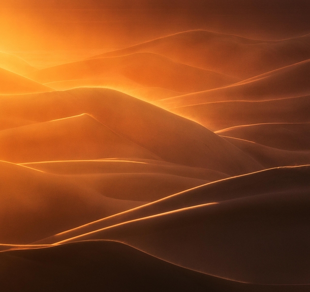Strong wind during golden hour makes for a fiery scene in Great Sand Dunes National Park Colorado 