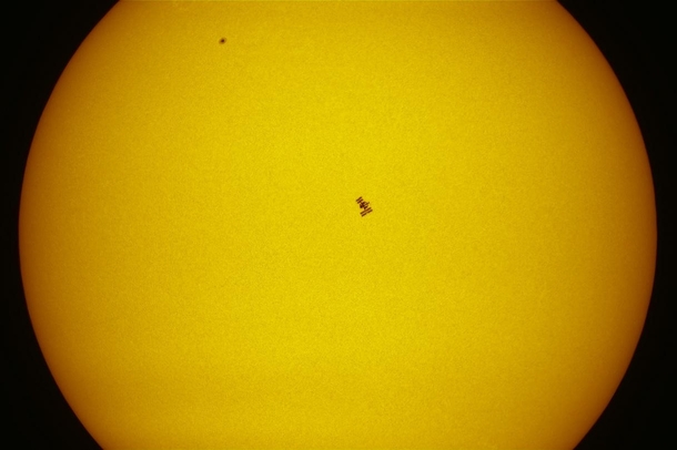 Stunning photograph of the ISS with docked Endavour in front of the Sun 
