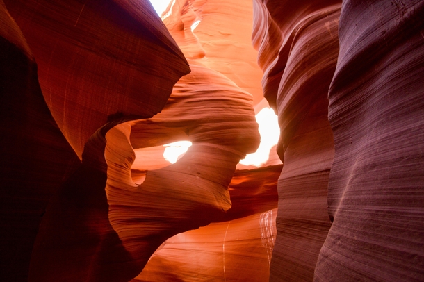 Sun reflection peaking through a natural hole in Antelope Canyon 