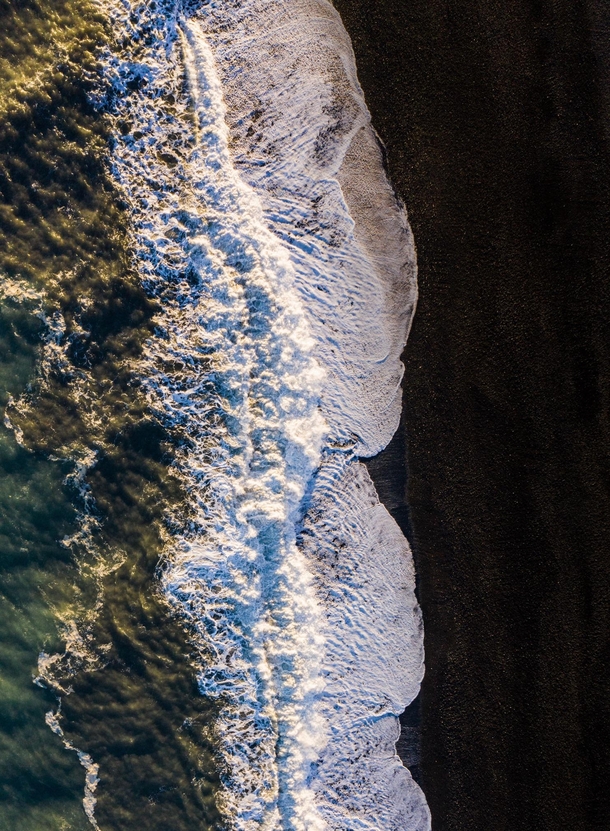 Sunlight enlightens the waves rolling in at a black sand beach in Iceland  - more of my abstract landscapes at insta glacionaut