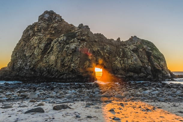 Sunlight shining through the Keyhole Rock in Big Sur California 