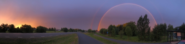 Sunrise and rainbow over a small village in the north of Sweden