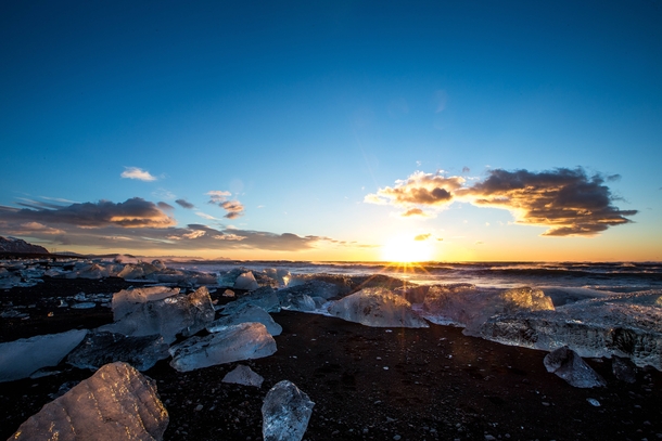 Sunrise on a beach filled with ice Iceland By Jace LeRoy - 