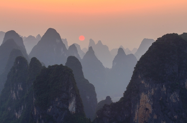 Sunset on top of Lao Zhai mountain at the bank of Li River China 