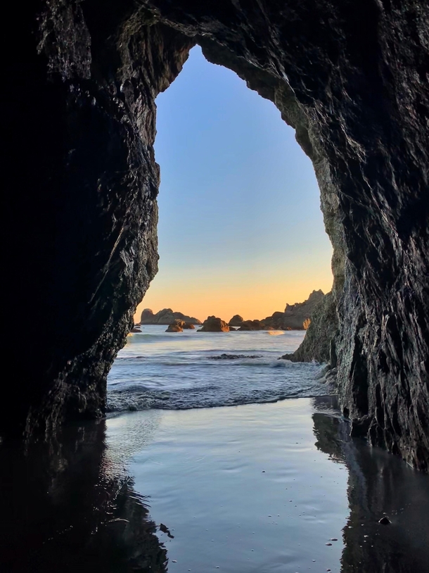 Sunset seen through a natural tunnel in Brookings OR 