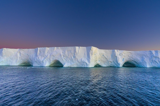 Tabular iceberg glowing in the Antarctic sunset 