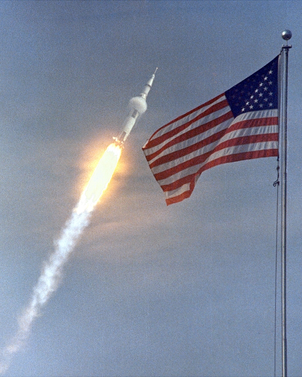 The American flag heralds the flight of Apollo  the first Lunar landing mission The Apollo  Saturn V space vehicle lifted off with astronauts Neil A Armstrong Michael Collins and Edwin E Aldrin Jr at  am on July   from Kennedy Space Centers Launch Complex