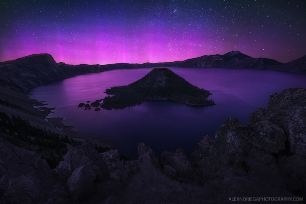 The Aurora Borealis does a rare dance over Crater Lake Oregon by Alex Noriega