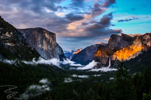 The clouds were rolling in the sun was setting a fiery glow to the rocks Yosemite valley CA 