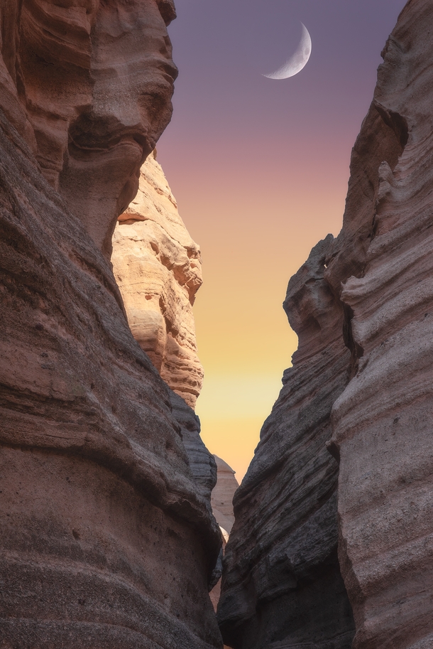 The crescent moon in between some canyons in Tent Rocks NM 