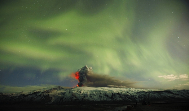 The Eyjafjallajokull volcano erupts in  with a stunning display of the Northern Lights in the background Iceland - 