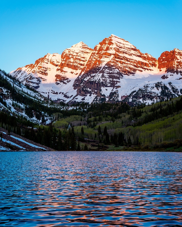 The first light of day strikes the Maroon Bells near Aspen CO 