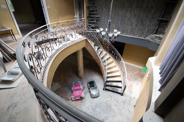 The foyer and grand spiral staircase in an abandoned mansion OC -   