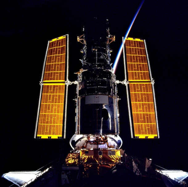 The gold of the solar arrays illuminated from behind by the sunrise provides stark contrast to the blackness of space in this scene photographed at the completion of the servicing of the Hubble Space Telescope in Dec  This photo was taken from NASAs Space