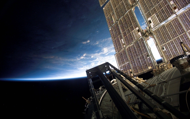 The ISS floats high above a serene blue Earth 
