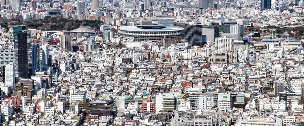 The Japan National Stadium towering above the mostly low-rise neighborhood of Jingumae Tokyo