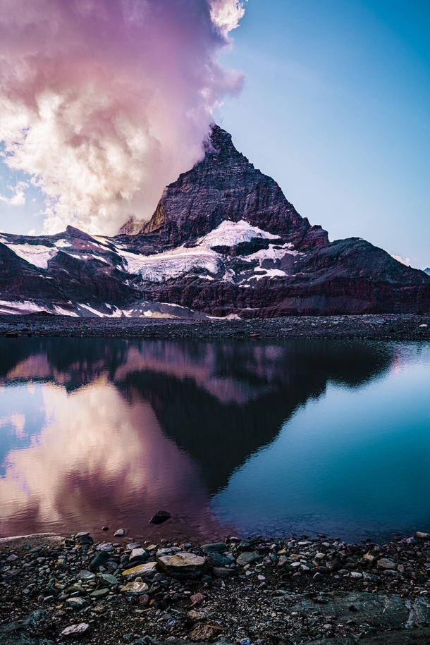 The Matterhorn in clouds with its reflection  x