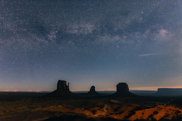 The Milky Way shining above Monument Valley - taken from a parking lot 