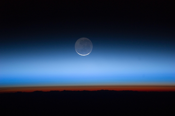 The Moon Seen from the International Space Station -- the limb of Earth is near the bottom transitioning into the orange-colored troposphere 