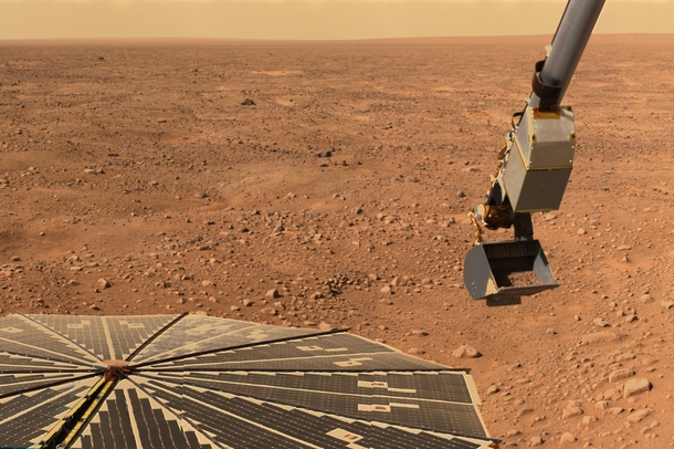 The Phoenix lander scoops up some Martian soil 