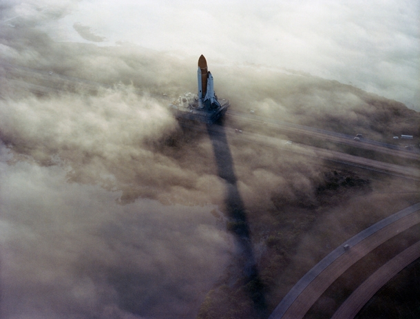 The Space Shuttle Challenger rolls through the fog toward the launch pad at Cape Canaveral November  