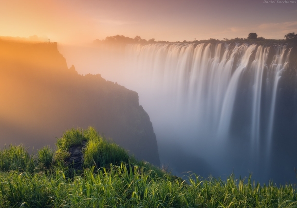 The sun lighting up fog created by the Victoria Falls Zambia  photo by Daniel Korzhonov