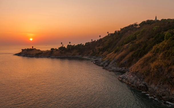 The sun sets over the southernmost point of Phuket Thailand 