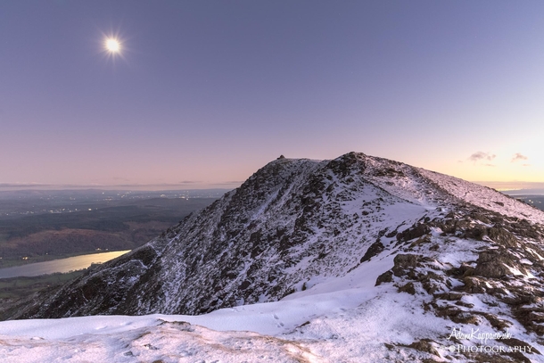 The sun setting behind Coniston Old Man as the moon rose over the water The Lake District 