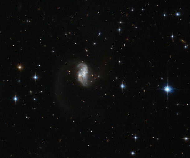 The twisted wormlike structure of this galaxy known as IRAS  is most likely the result of a collision and subsequent merger of two galaxies 