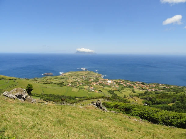 The village of Ponta Delgada on Flores Island Azores with Corvo Island in the distance 