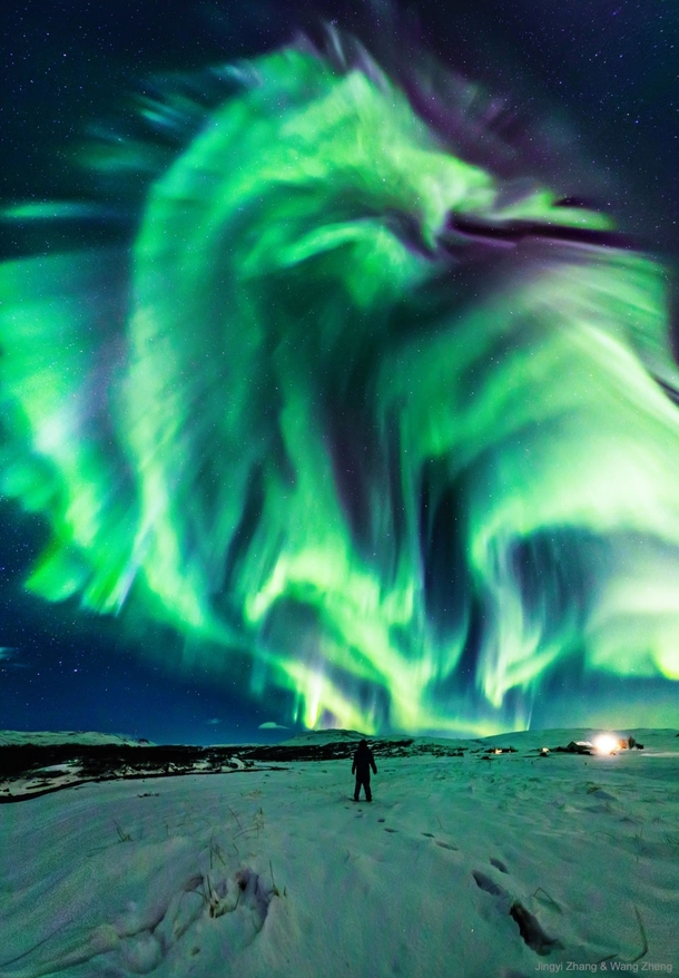 This enthralling dragon aurora appeared in the sky over Iceland The person captured in the foreground is the photographers mother Credit Jingyi Zhang amp Wang Zhang 