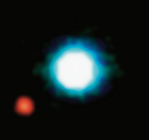This is an infrared image of Mb red orbiting the brown dwarf M blue In  this was the very first image of an exoplanet to be captured Mb is five times more massive than Jupiter and orbits M at a distance of  AU 