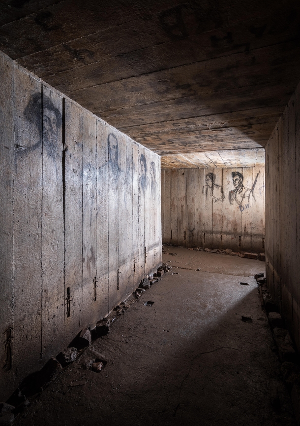 This was taken underground in an air raid shelter The portraits on the walls are believed to of been of the occupants hand drawn whilst they waited for the all clear 