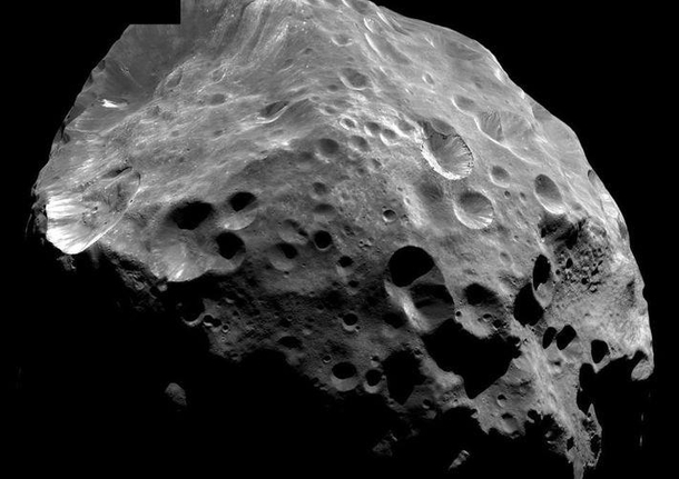 Unlike all of Saturns other moons Phoebe orbits in the opposite direction It is most likely a captured asteroid