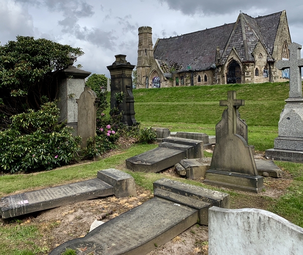 Unminded headstones surround unminded church Liverpool UK