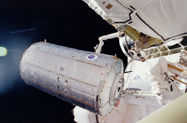 US Destiny Laboratory being moved from Space Shuttle Atlantiss cargo bay to be docked to the International Space Station in   x-post rtechnologyporn