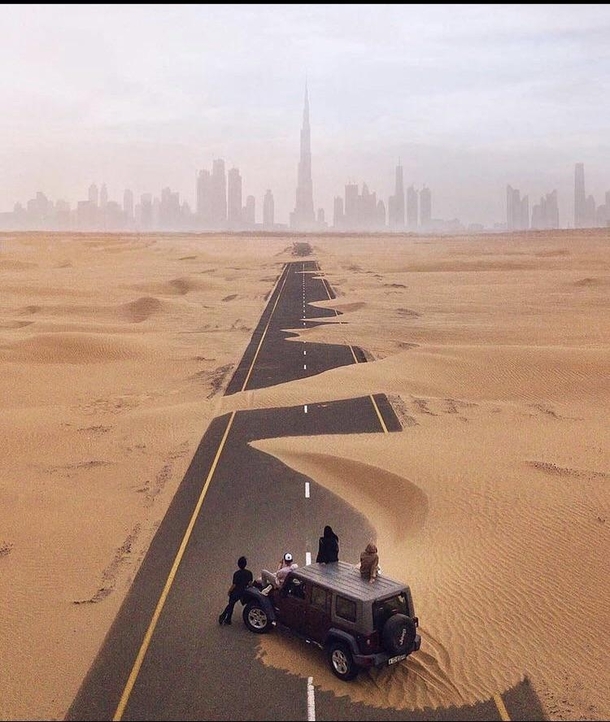 View of Dubai  from a sand covered road
