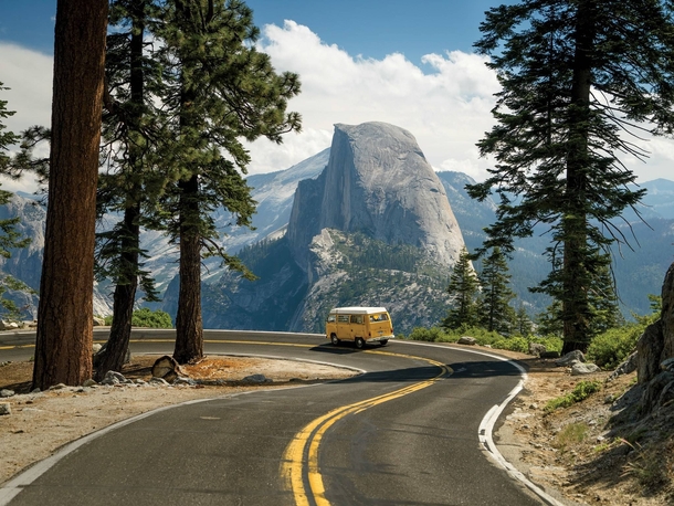 VW Camper Driving with a Beautiful View of Half Dome Yosemite National Park California   Chris Burkard