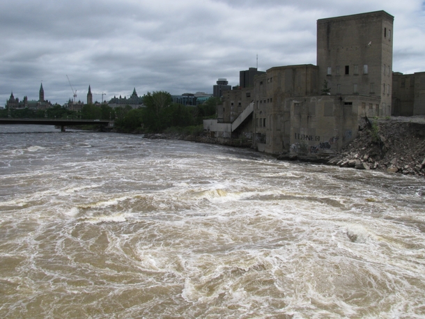 Water Churns Against Abandoned Factory Just Past Chaudire Falls Parliament in the Background 