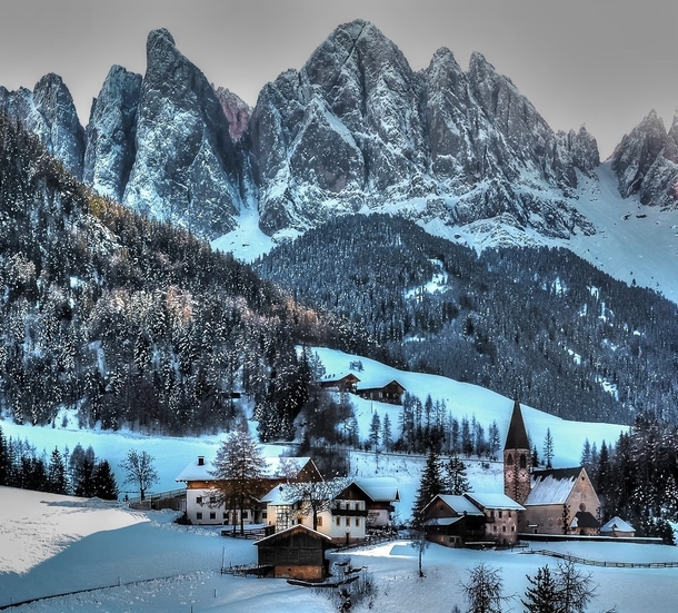 Winter at the Italian village of Funes at the base of the Dolomites 
